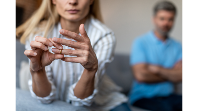 woman removing wedding ring while divorcing husband