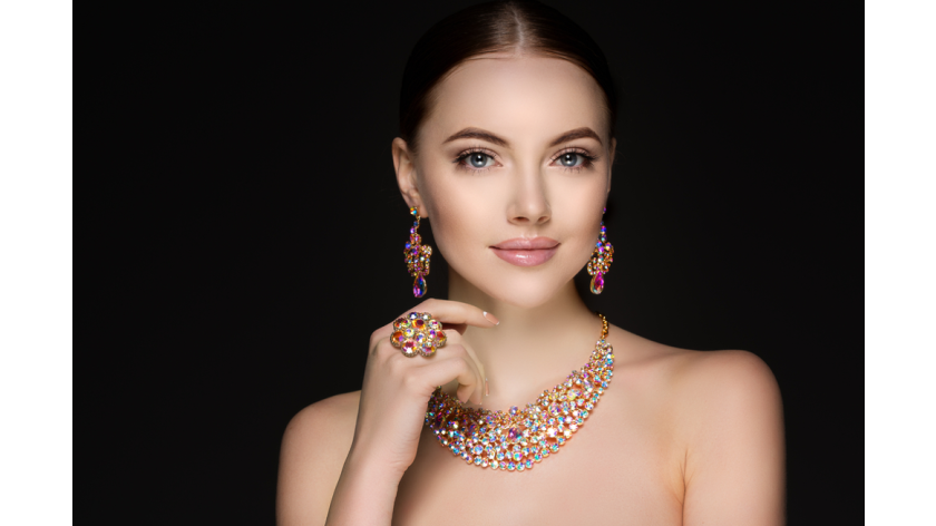 woman wearing high jewelry set of necklace, earrings, and a ring