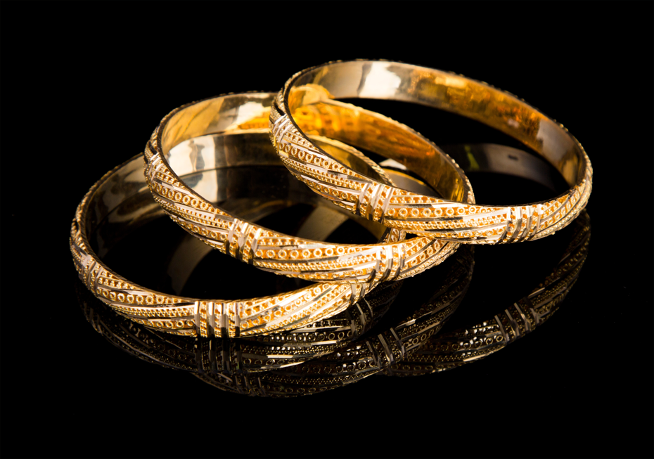 three 18 karat gold bracelets